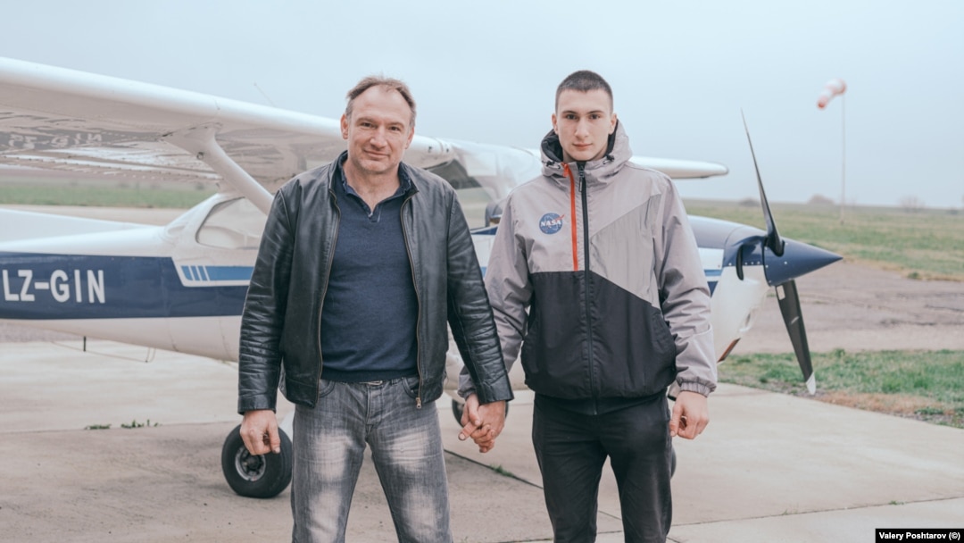 Bulgaria -- Father and Son portraits of men holding hands by Valery Poshtarov