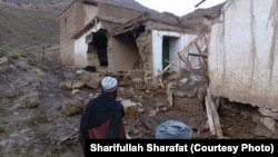 Afghan men look at destruction after a flash flood in Maidan Wardak Province.