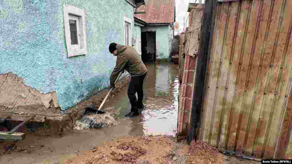 A villager clears muck near his home in Koyandy, a village some 20 kilometers northeast of the nation&#39;s capital, Astana. Residents of Koyandy took to the streets and barricaded the roads, furious at the authorities&#39; inability to prepare for the seasonal floods.&nbsp;