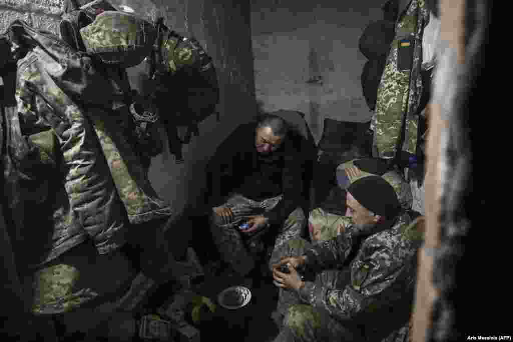 Ukrainian soldiers rest in their basement shelter. Russia, which refers to Bakhmut by its Soviet-era name of Artyomovsk, says that capturing the destroyed city will allow it to launch more offensives deeper into Ukrainian territory.