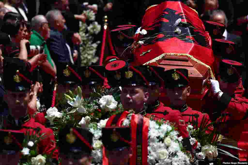 People pay tribute as guards carry the coffin of Albanian novelist and playwright Ismail Kadare, who died at the age of 88, during his state farewell ceremony at the National Theatre of Opera and Ballet in Tirana on July 3.