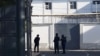 Muhsinjon Ahmedov (right) is escorted under police escort outside a detention facility in the city of Qoqon, Uzbekistan.