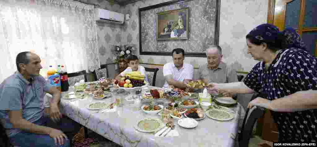 A Kyrgyz family prepares for a meal during the celebration of the Muslim festival of Eid al-Adha in the village of Kok-Zhar near Bishkek.&nbsp;