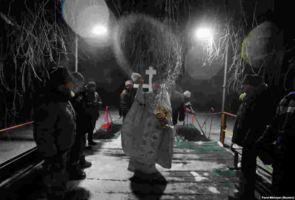 A priest conducts an early morning celebration in freezing temperatures in Almaty, Kazakhstan.