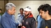 Pakistani Interior Minister Mohsin Naqvi (left) greets a student injured in the Bishkek attacks, at Lahore airport on May 18. The Pakistani Embassy in Bishkek announced special flights to bring students home over the next few days. 