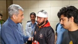 Pakistani Interior Minister Mohsin Naqvi (left) greets a student injured in the Bishkek attacks, at Lahore airport on May 18. The Pakistani Embassy in Bishkek announced special flights to bring students home over the next few days. 