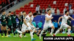 Tajikistan's players celebrate after the penalty shoot-out of the Qatar 2023 AFC Asian Cup football match between Tajikistan and U.A.E. at Ahmad Bin Ali Stadium in Al-Rayyan on January 28.