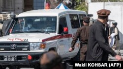 An ambulance carries victims from the site of a suicide attack in Kabul on March 27.