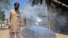 Local blacksmith Ghulam Abbas tests a solar stove that he built at his workshop in Kabul on May 8. The parabola-shaped solar heaters have grown in popularity in Afghanistan as the country is in the grip of a chronic energy crisis.