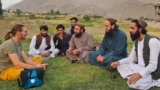 A German tourist talks to local residents and Taliban officials in the northern province of Panjshir.