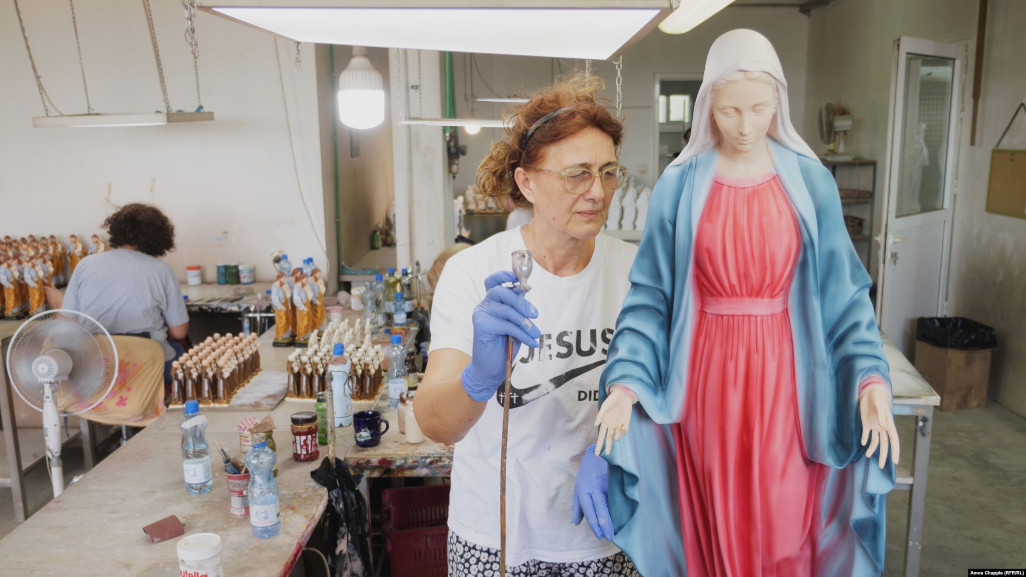 A woman paints a statue of the Virgin Mary in a factory on the outskirts of Medjugorje on August 2.