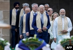 Premierul indian Narendra Modi, președintele american Joe Biden, cancelarul german Olaf Scholz, împreună cu alți lideri mondiali, sosesc la memorialul Mahatma Gandhi de la Raj Ghat, pe 10 septembrie 2023.