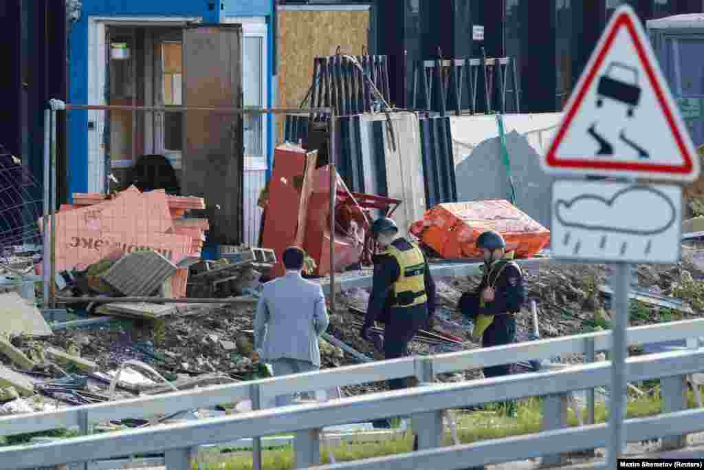 Members of the security services investigate the debris near the Moscow building that was reportedly struck by a drone. &quot;A Kyiv regime attempt to carry out a terrorist act using two drones on objects on the territory of the city of Moscow was stopped,&quot; Russia&#39;s Defense Ministry said. &quot;Two Ukrainian drones were&nbsp; suppressed and crashed. There are no casualties.&quot;