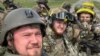 Members of the Russian Volunteer Corps pose for a picture atop an armored vehicle at a border crossing in Kozinka, Belgorod region, Russia, in this handout picture released on May 23.