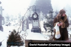 A woman in a cemetery in Iasi in January 1988