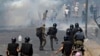 Police use tear gas to disperse Pakistan Tehreek-e-Insaf party activists and supporters of former Pakistani Prime Minister Imran Khan during a protest against his arrest in Lahore on May 10.