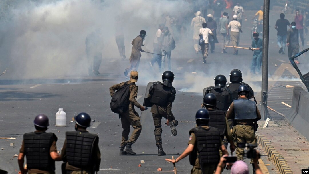 Police use tear gas to disperse Pakistan Tehreek-e-Insaf party activists and supporters of former Pakistani Prime Minister Imran Khan during a protest against his arrest in Lahore on May 10.