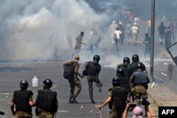 Police use tear gas to disperse PTI supporters during a protest against the arrest of their leader in the eastern city of Lahore on May 10.