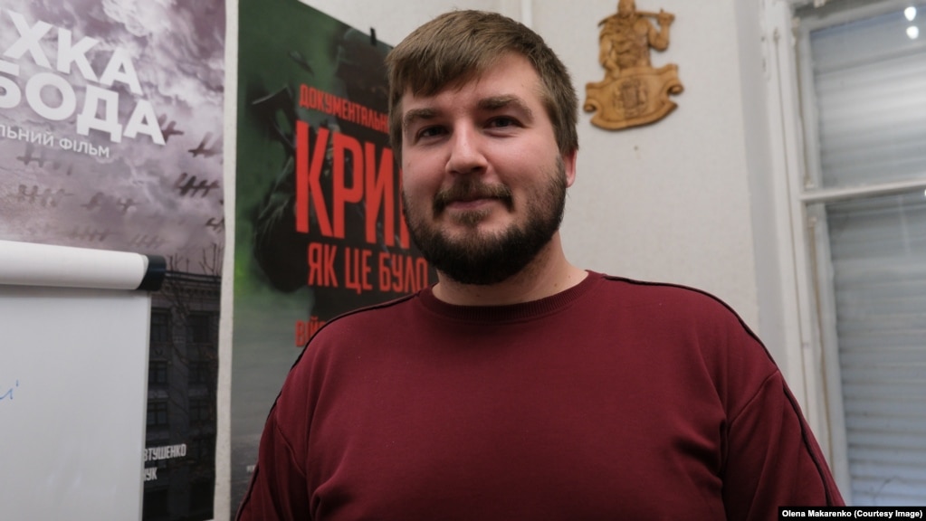 Kostyantyn Klyatskin con il poster del suo documentario, intitolato Crimea As It Was, sullo sfondo.