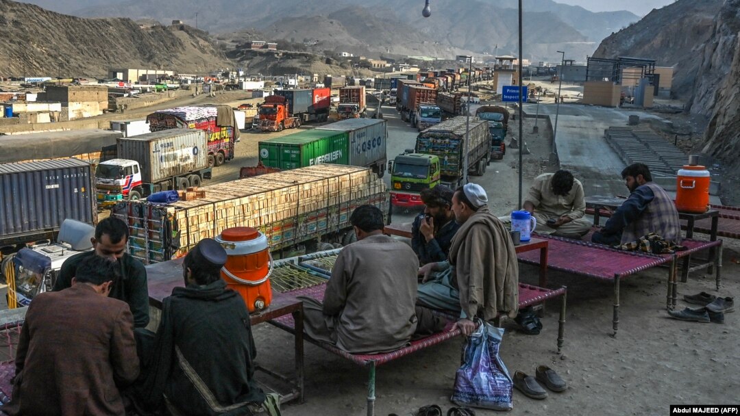 Drivers rest as stranded trucks are pictured near the Pakistan-Afghanistan border at Torkham on January 16. 