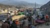 Drivers rest on the roadside as stranded trucks are pictured near the Pakistan-Afghanistan border in Torkham during a previous closure in 2024. 