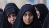 Iranian women wait in line to vote at a polling station in a snap presidential election in Tehran on June 28.<br />
<br />
Iranians will choose between mostly hard-line candidates to choose a successor to Ebrahim Raisi following his <a href="https://www.rferl.org/a/iran-president-ebrahim-raisi-obituary/32953936.html" target="_blank">death</a> in a helicopter crash.
