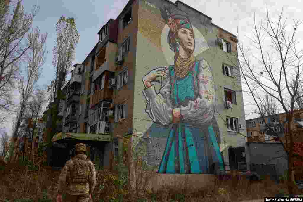 &nbsp;A Ukrainian soldier walks next to a damaged apartment building.&nbsp; A key transportation hub, Avdiyivka, is just 15 kilometers north of the Russian-occupied city of Donetsk. It has been under siege since Moscow launched a major offensive earlier in October.