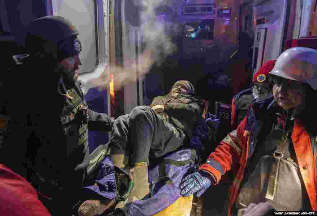 An elderly woman is transported to a hospital by rescuers following the Kharkiv attack. Located just 30 kilometers from the border with Russia, Kharkiv has come under frequent bombardment since Moscow launched its full-scale invasion of Ukraine in February 2022. &nbsp;