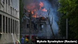 Rescuers work at the site of a clinic hit by a Russian missile strike in Dnipro on May 26.