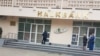 Turkmenistan. Two women talk and one man withdraws money from ATM in front of the one of the branches of Halkbank in Ashgabat. ATMs, bank.