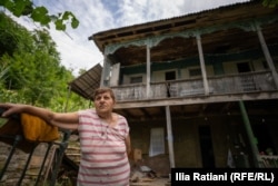 Nunu Kakhidze stands in front of her home.