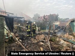 Rescuers work at the site of buildings damaged overnight by Russian drone and missiles strikes in the Kyiv region on August 30.