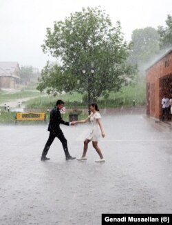 High school students dance outside the Stepanakert Cathedral during their graduation ceremony. The city is known as Xankandi in Azeri.