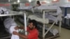 Pakistani volunteers adjust the dead bodies of heatwave victims at a morgue in Karachi late last month. 