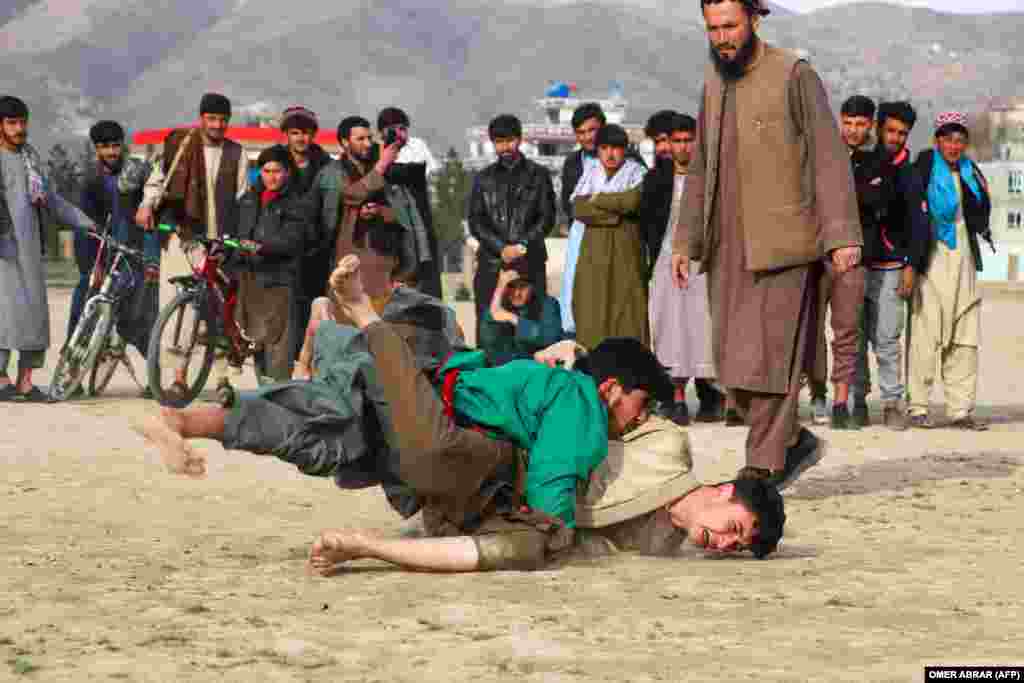 Traditional Afghan wrestlers compete in a field in Fayzabad.