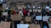 UKRAINE -- People hold posters reading "Return defenders of Mariupol", "Free Azov", and others, during a demonstration in central Kyiv, Ukraine, Sunday, Dec. 3, 2023.