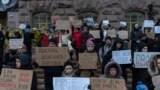 UKRAINE -- People hold posters reading "Return defenders of Mariupol", "Free Azov", and others, during a demonstration in central Kyiv, Ukraine, Sunday, Dec. 3, 2023.