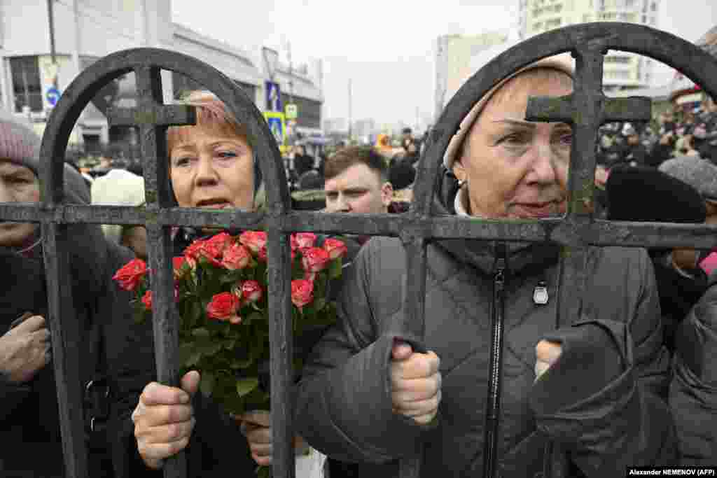 Mourners pay tribute to Navalny outside the church.