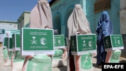Afghan women receive food aid distributed by the Malik Suleiman Charity Foundation in Kandahar in June.