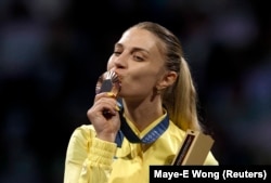 Olha Kharlan celebrates Ukraine's first medal of the 2024 Paris Olympics by kissing her bronze on July 29.