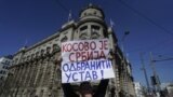 Belgrade, Serbia - protest and blockade in front of the government against the agreement with Kosovo, March 24, 2023 -- A man holds a banner reading: ''Kosovo is Serbia: defend the constitution!'' 