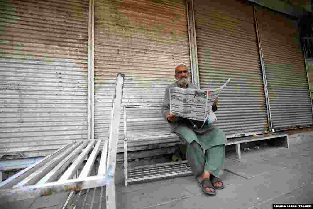 A man reads a newspaper outside a closed currency exchange shop in Peshawar.&nbsp; Pakistan&rsquo;s rupee is the worst-performing Asian currency this quarter, depreciating nearly 6 percent against the dollar and establishing a new record low in September. &nbsp;