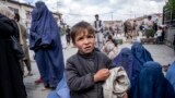 A woman and boy beg for alms outside a mosque during Ramadan in Kabul. (file photo)