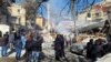 People inspect the damage at the site of a reported Israeli strike in the Mazzeh neighborhood of Damascus, Syria, on January 20. 