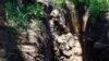 A soldier of the 68th Independent Jager Brigade enjoys a cigarette in his trench during a lull in fighting on the front line in the southern Donetsk region on May 5.