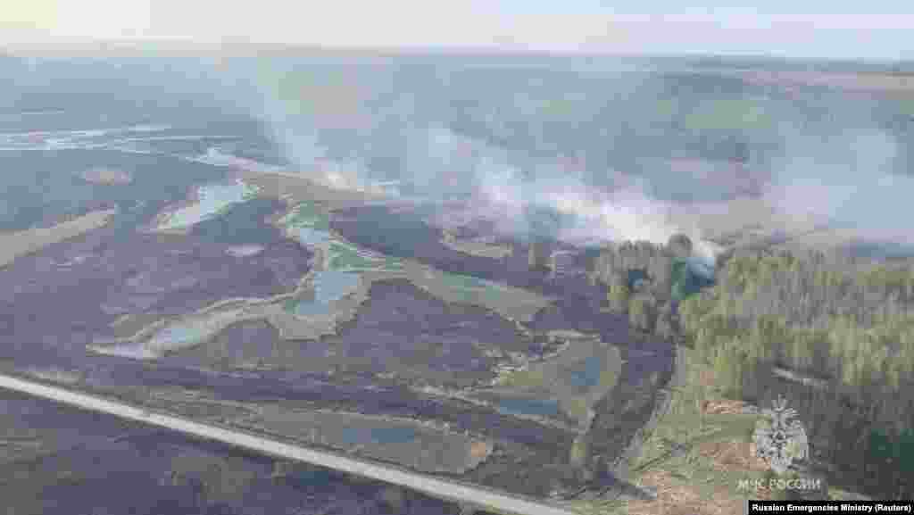 A view from a helicopter shows smoke rising from a wildfire in the Kurgan Region&nbsp; in this still image taken from video released May 8.