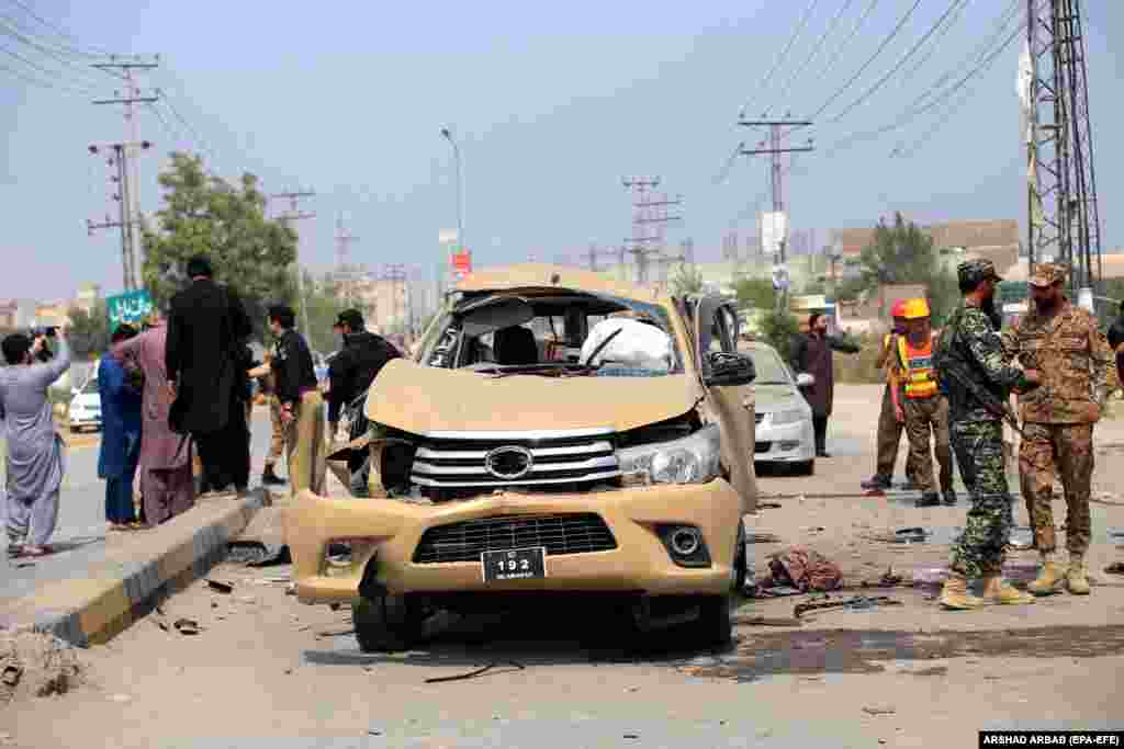 Pakistani security officials inspect the scene of an explosion that targeted a vehicle of the paramilitary Frontier Corps in Peshawar. At least one Frontier Corps official was killed and nine others, including six Frontier Corps personnel, were injured.