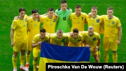 Ukrainian players pose with their flag before their match against Slovakia in Dusseldorf on June 21.