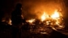 A firefighter extinguishes a fire in a parking area sparked by the falling remains of a Russian missile in Kyiv on May 16. 