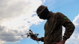 Український морпіх тримає FPV-дрон під час льотних тренувань у Дніпропетровській області, травень 2023 року